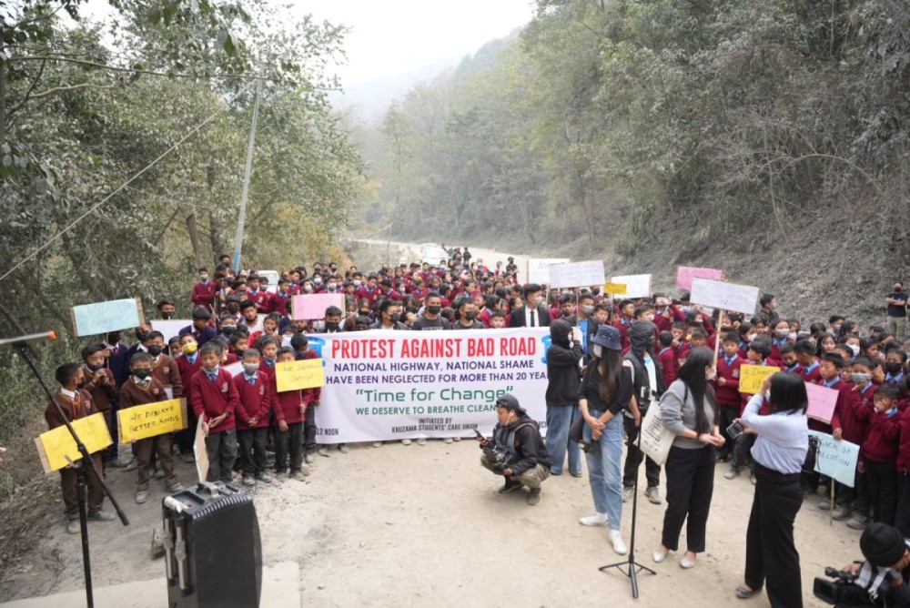 Students with placards join the protest organised by Khuzama Students' Care Union against bad roads along the National Highway-2 Khuzama village on March 11. (Photo Credit: KSCU)